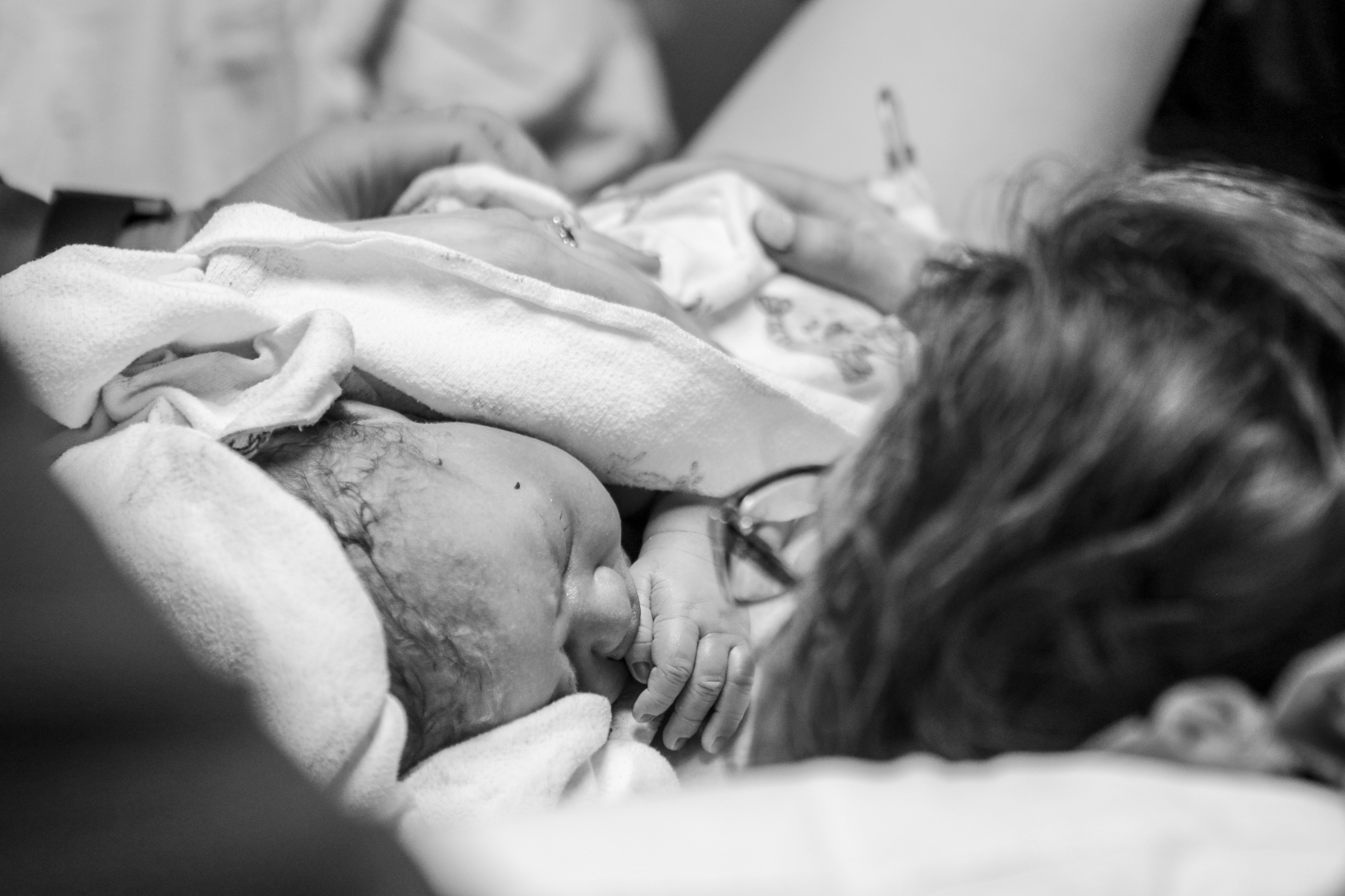 Mother's Day: A newborn baby being help by her mother for the first time